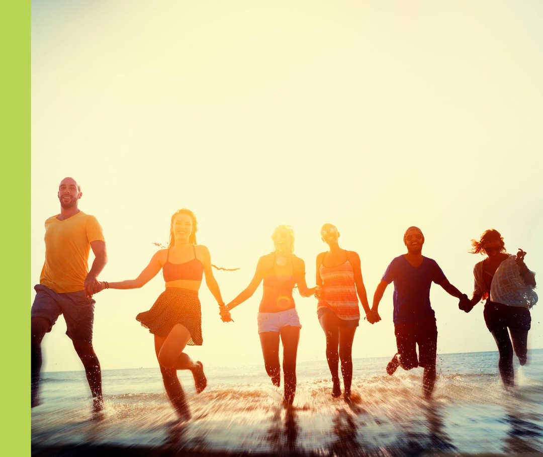 Menschen laufen Hand in Hand aus dem Meer an den Strand.